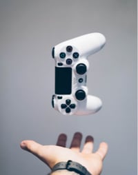 Image of a gaming controller over a hand